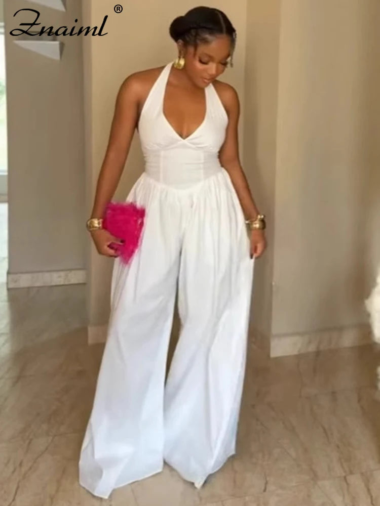 Mono elegante fiesta mujer pierna ancha espalda descubierta cuello halter blanco negro outfit formal
